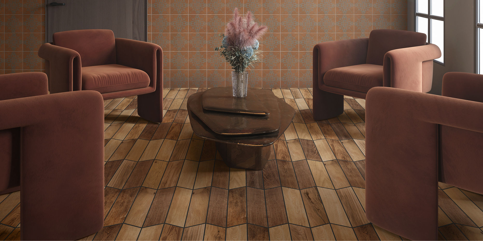 Living area with 4 brown chairs, wood look chevron floor tile, and orange encaustic tile on back wall.