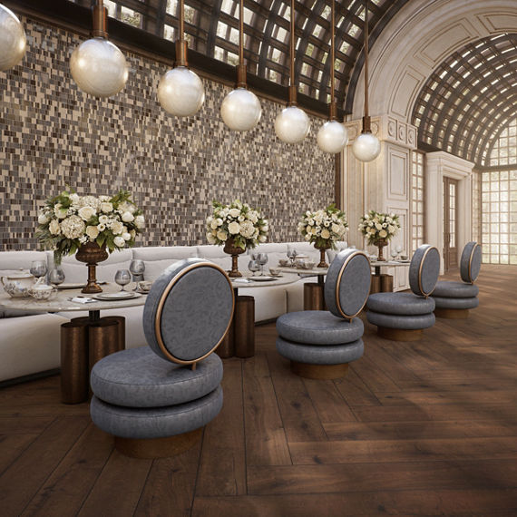 Restaurant with wood look plank floor tile, beige glass mosaic on back wall, white couches, and blue chairs.