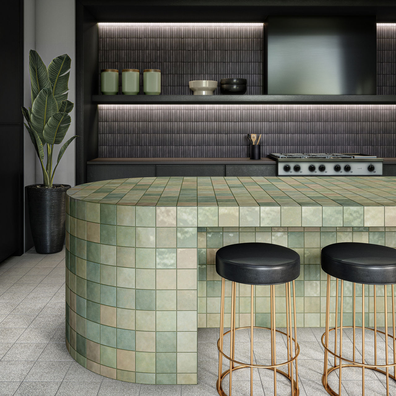 Kitchen with green square tile on island, black counters, white square floor tile, and two black chairs at island.