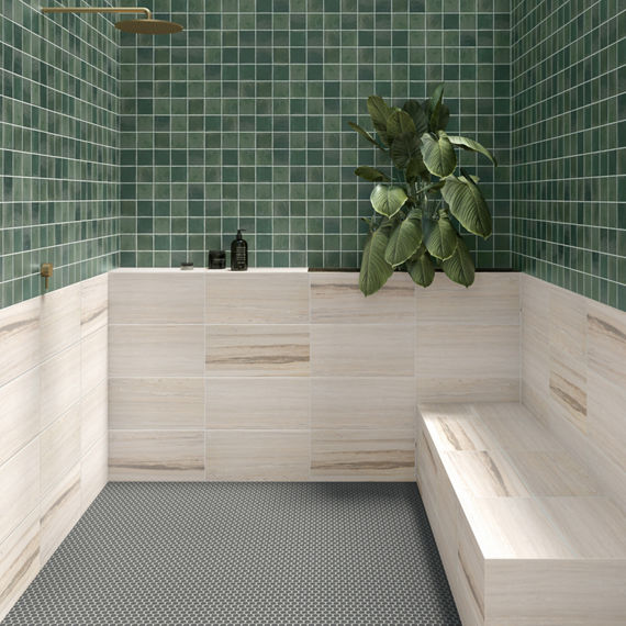 Bathroom with green square tile on top half of walls, white stone look tile on bottom half of walls, and silver accents.