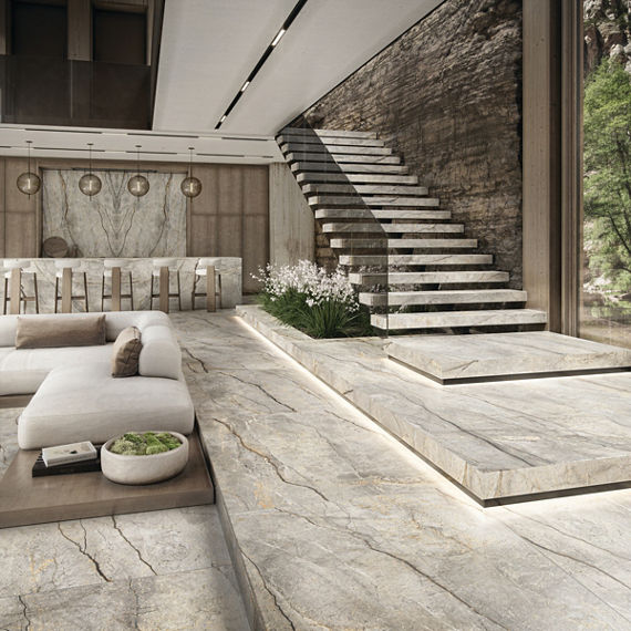 High end living room with bar, white couch and bar chairs, stairs, and white marble look porcelain slab on stairs and floor, and white marble look porcelain slab on bar counter and backsplash.