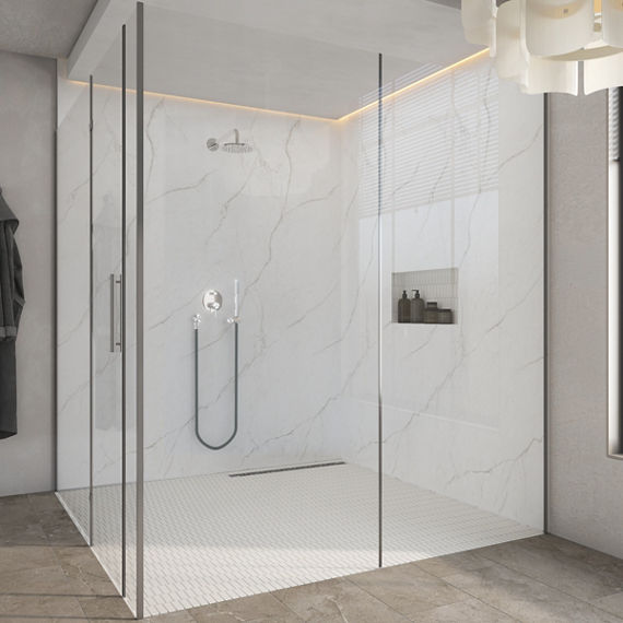 Shower with panoramic porcelain wall panels featuring soft veining, clear glass enclosure, chrome fixtures, a built?in niche with bottles, and a light hexagon shower floor.