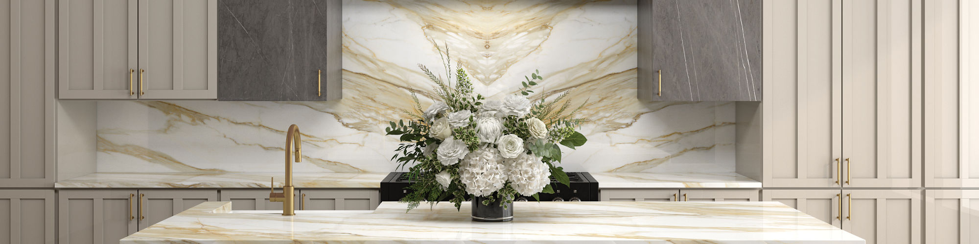 Kitchen with white marble look porcelain slab island and backsplash, gray marble look porcelain slab on vent hood, wood look floor tile in herringbone pattern, and gold accents.