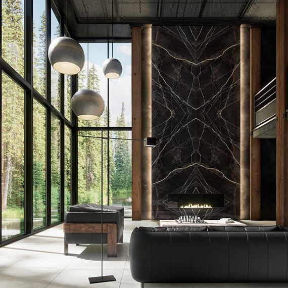 Living room with black couch and sitting chair, black marble look porcelain slab surrounding fireplace, and fireplace lit.