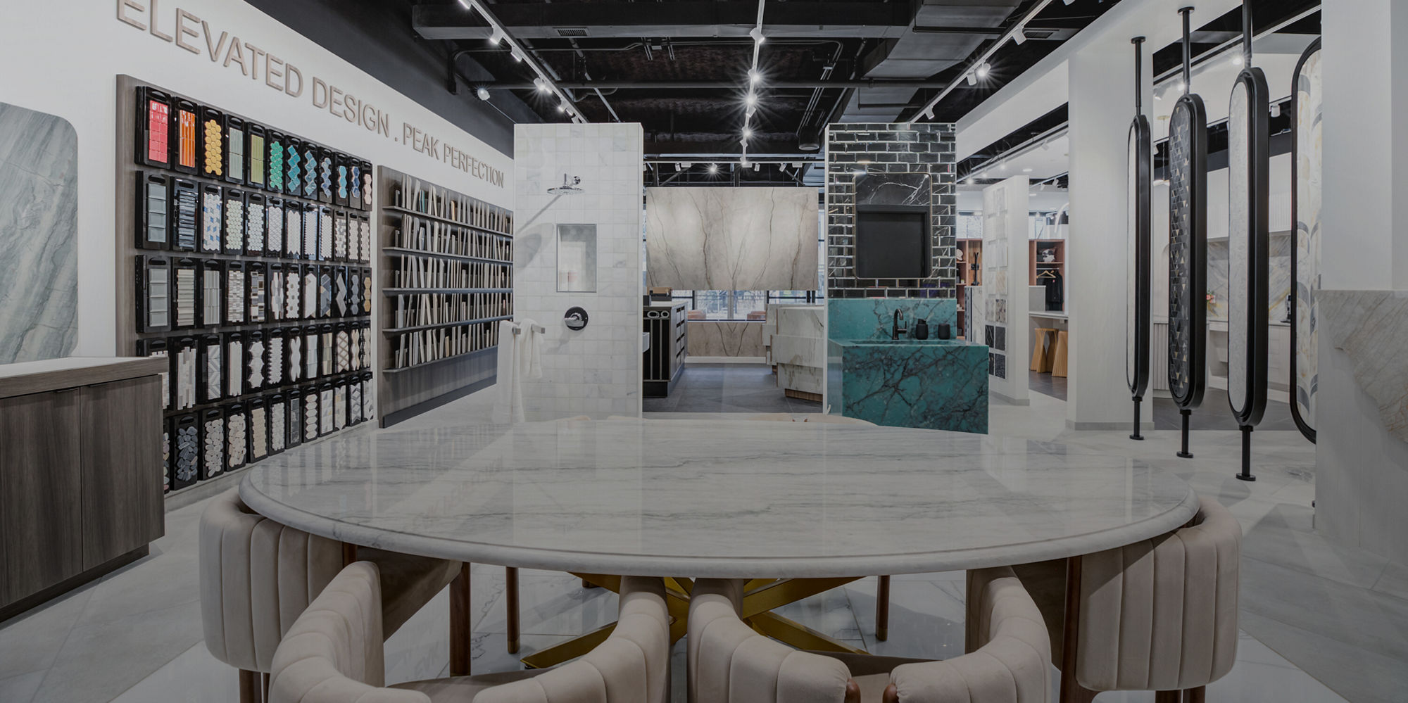 Assorted marble look tiles, mosaics, and trim pieces arranged in a coordinated flat lay.