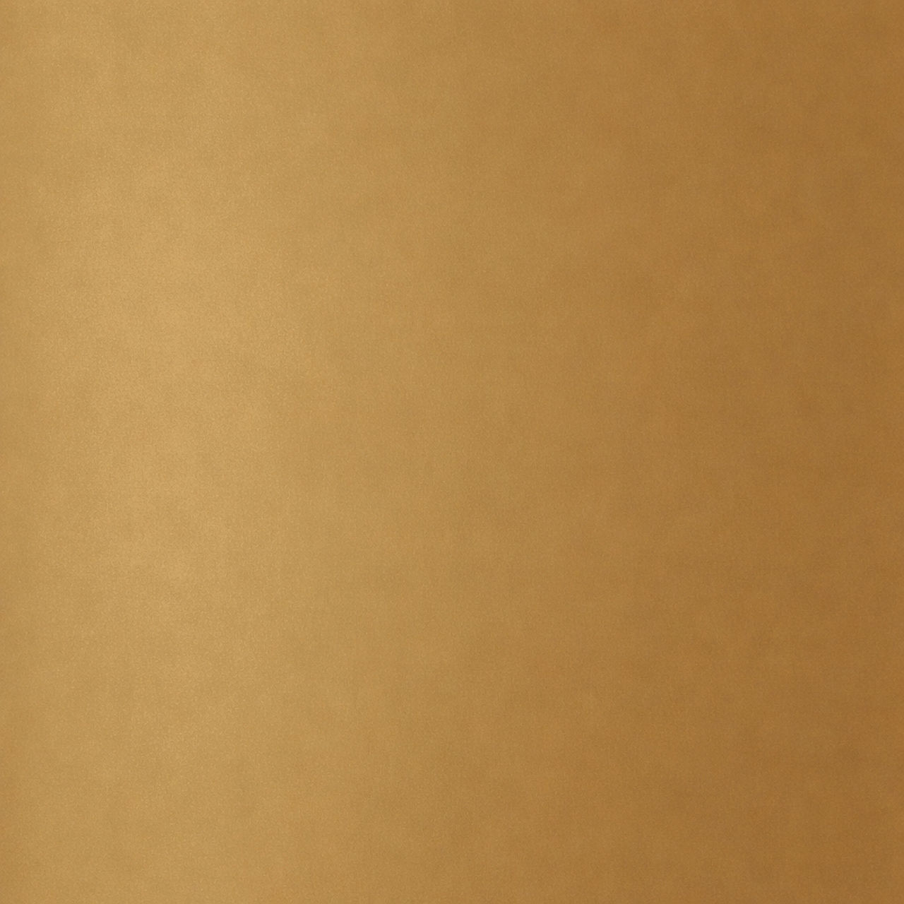 A warm golden brown surface fills the entire frame, creating a simple and uniform background. The texture appears soft and slightly mottled, with subtle variations in tone. There are no objects, people, or text visible in the image. The overall look 
