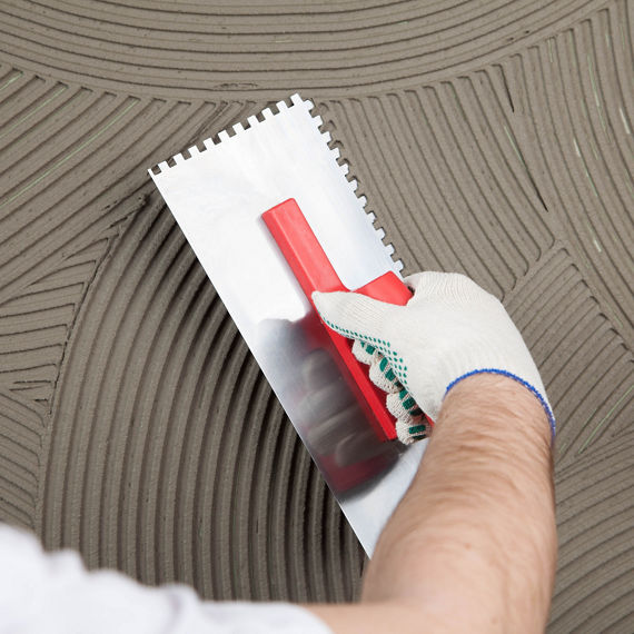 Hand of builder worker plastering