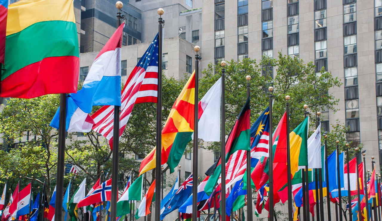 Rows of flags of all nations next to UN.
