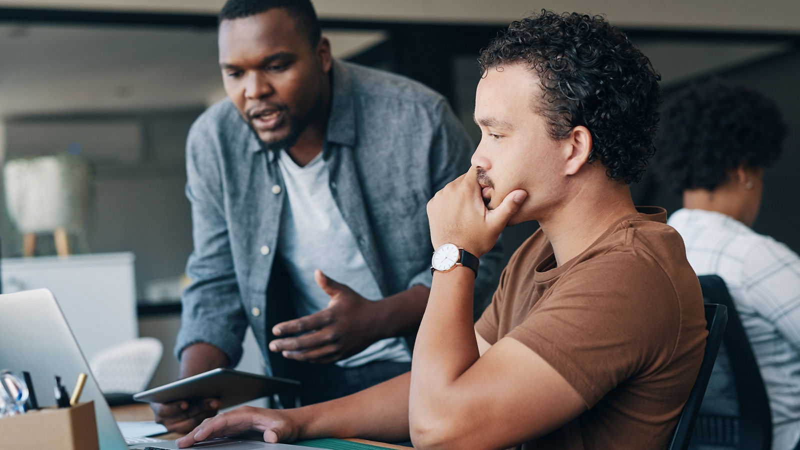 Shot of two young businessmen working together in an office.