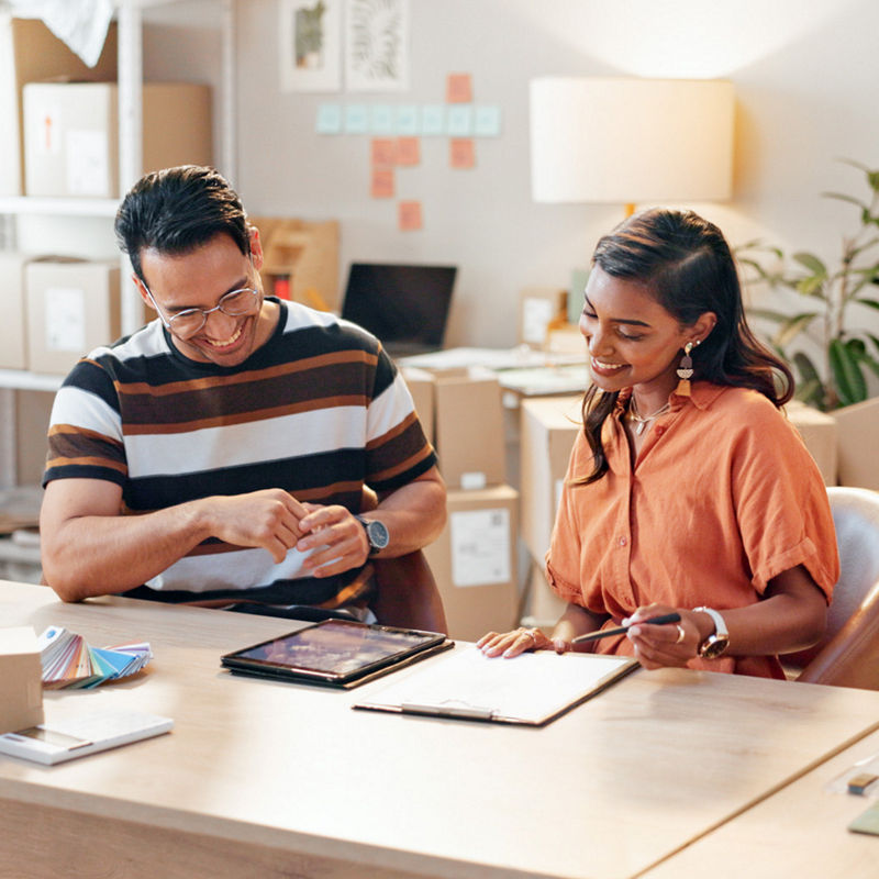 People collaborating on e-commerce business in a small office setting