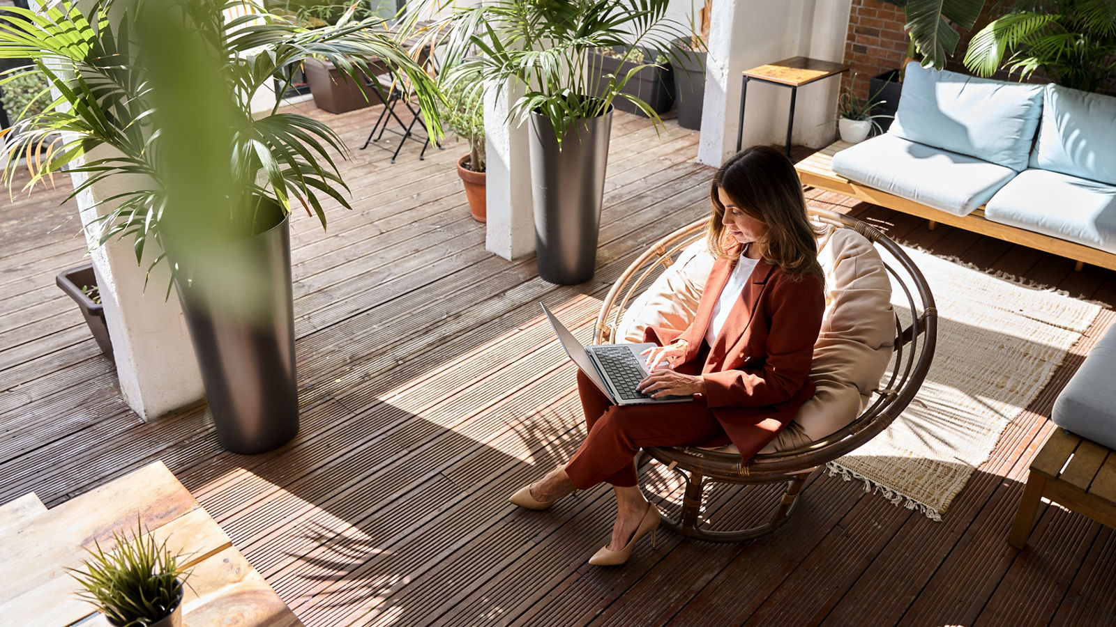 Business woman sitting in comfortable chair in sunny office.