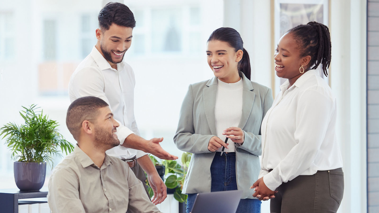 Business people, meeting and laughing with laptop at office for collaboration or team building in boardroom