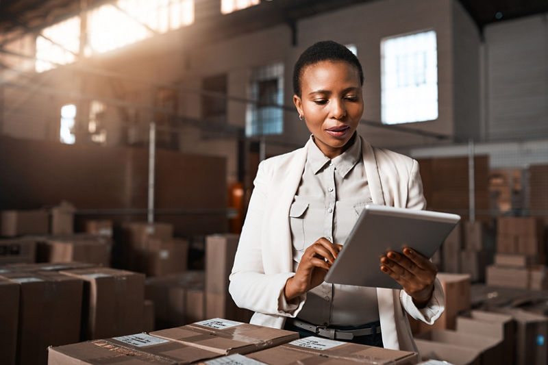 Manager taking inventory in supply factory