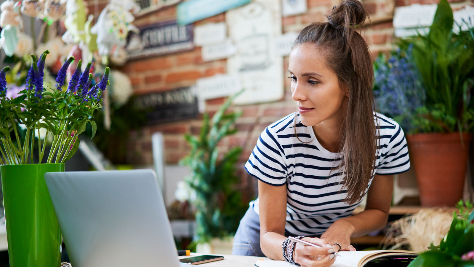 Florist business owner looking at laptop