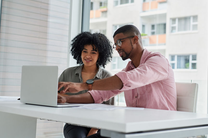 Shot of two businesspeople working together on a laptop in an office