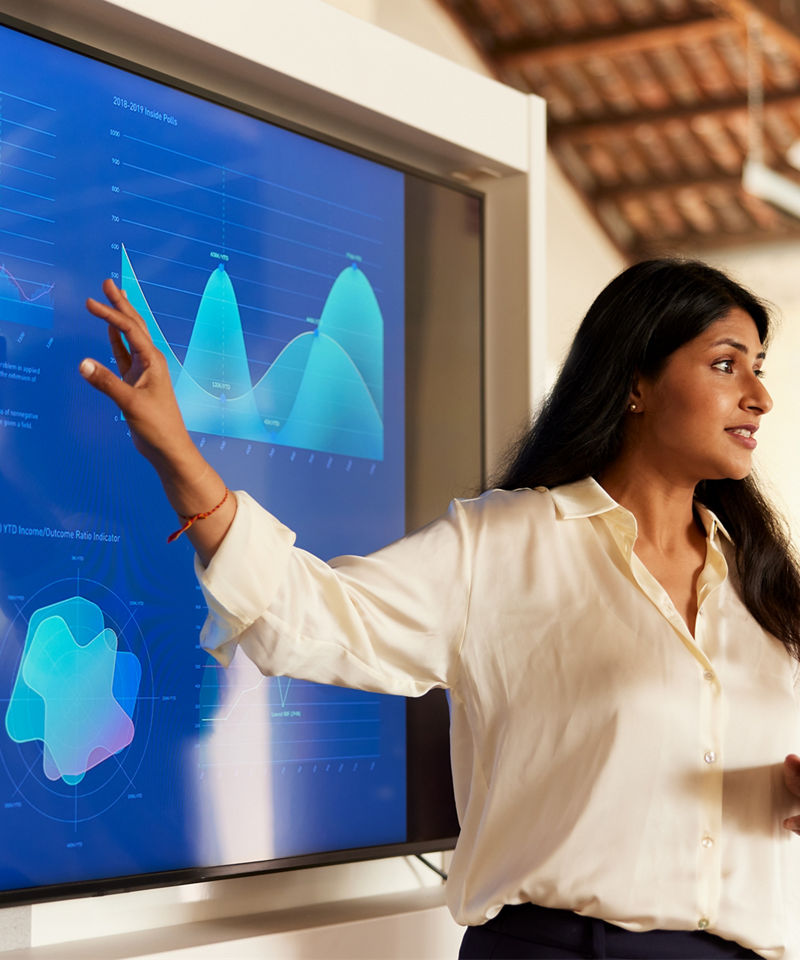 Business woman pointing at screen full of data visualization