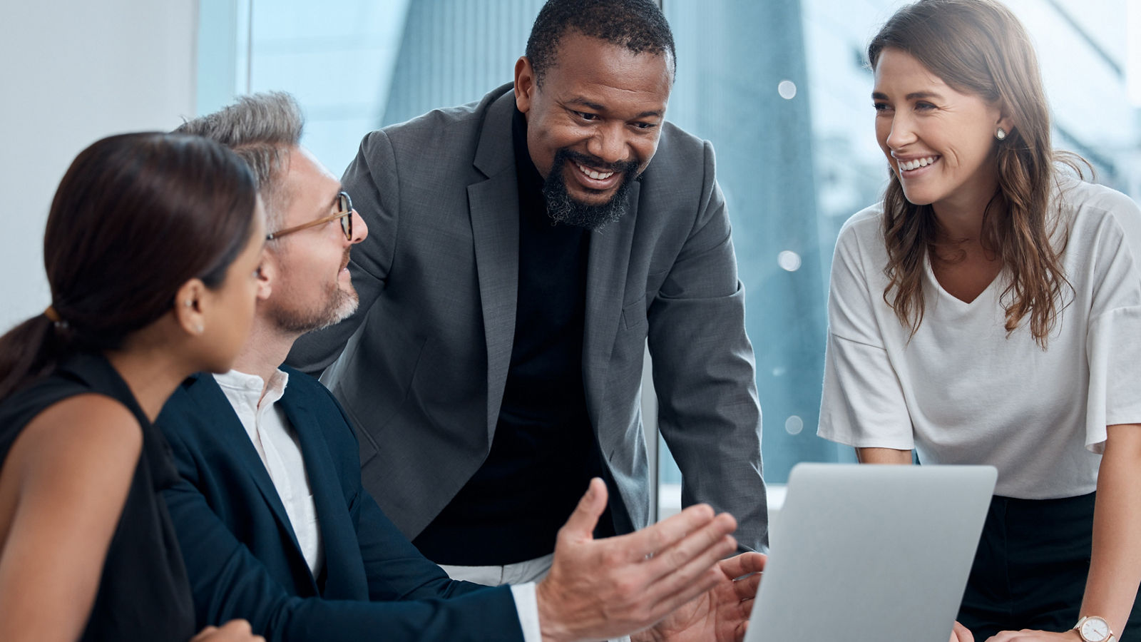Financial workers discussing business over laptop in office