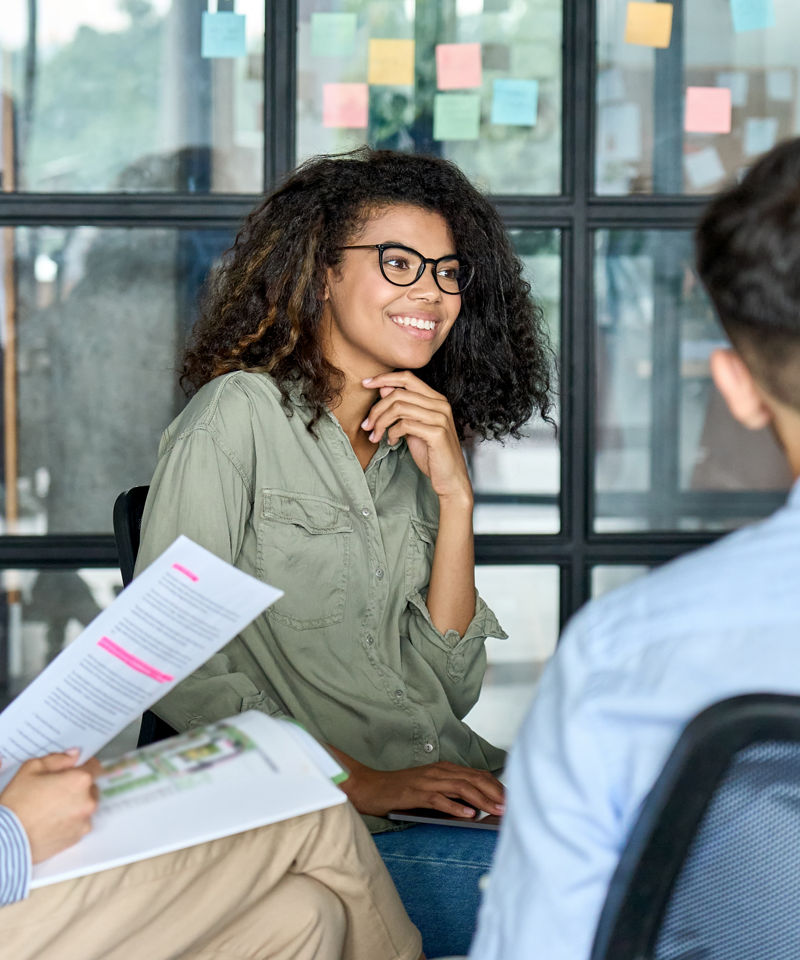 Intern brainstorming ideas among coworkers