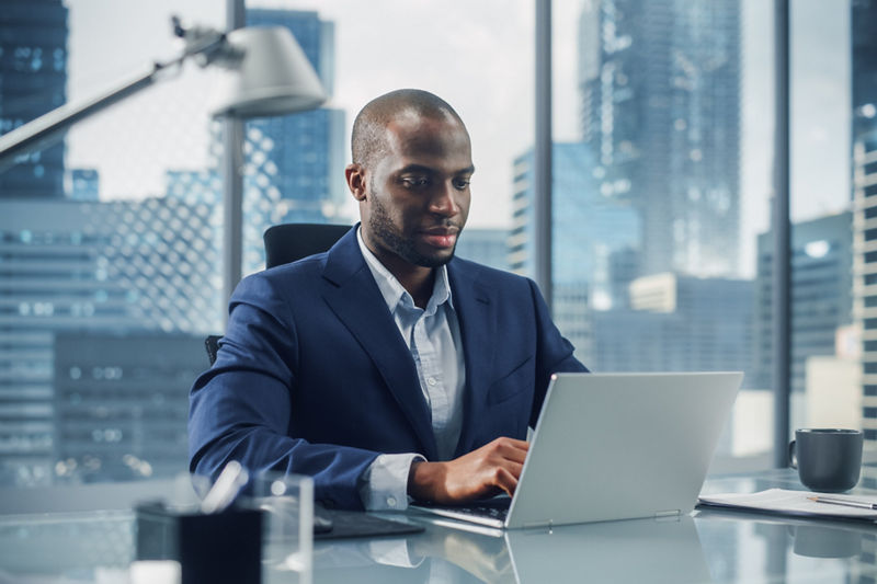 Lawyer sitting in office on laptop doing work in office