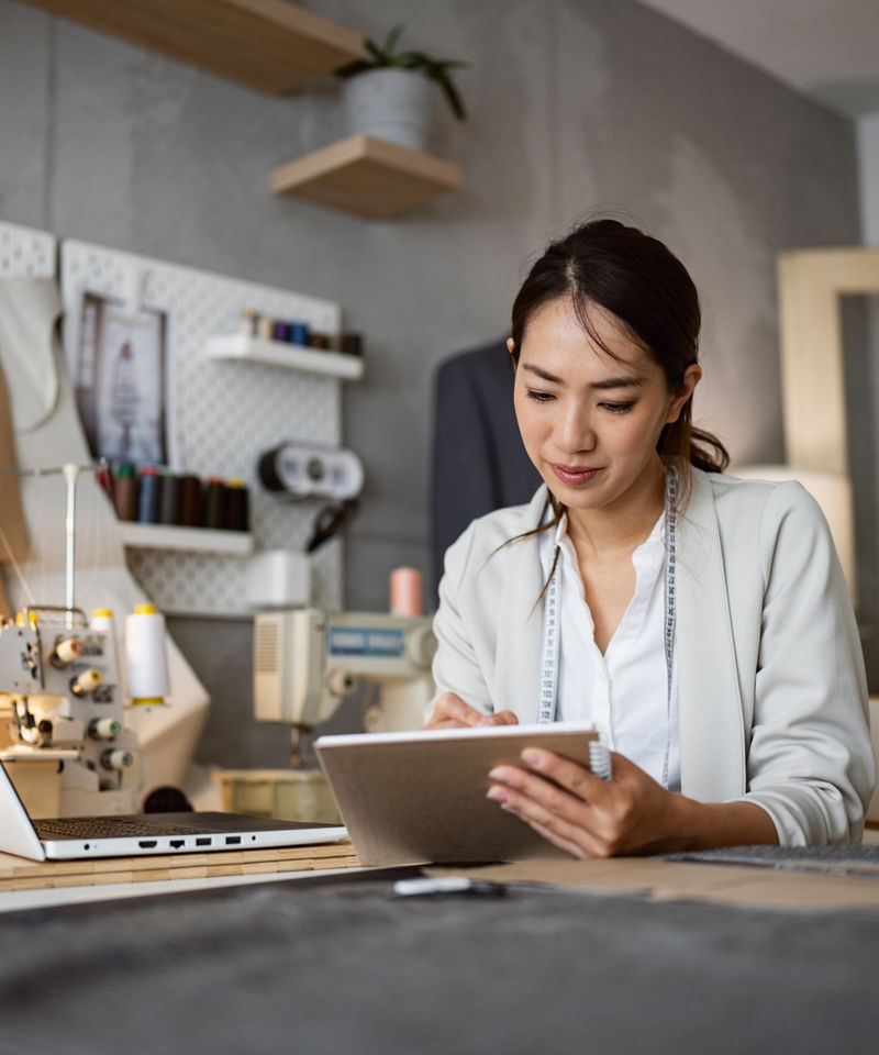 Small business owner in studio working on her tablet