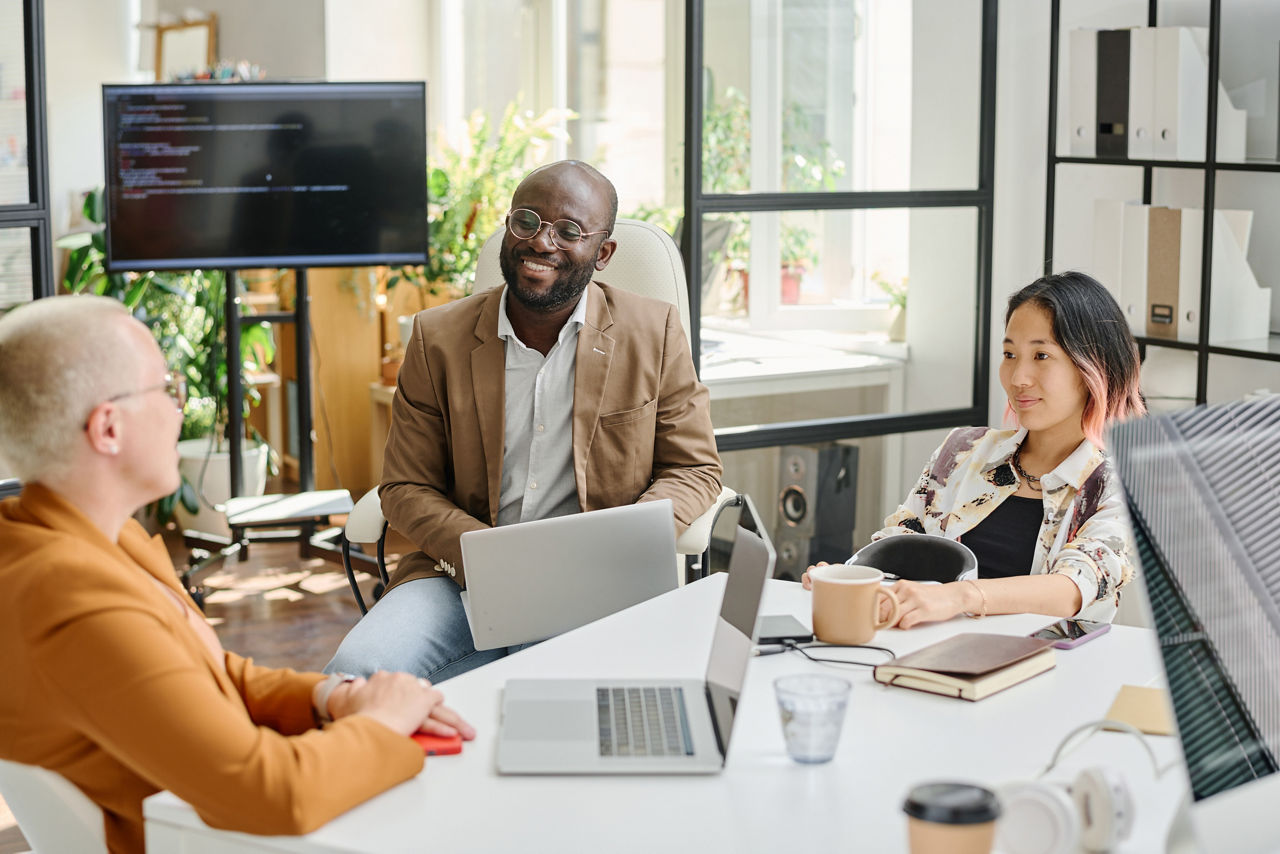 Team of programmers sitting at table