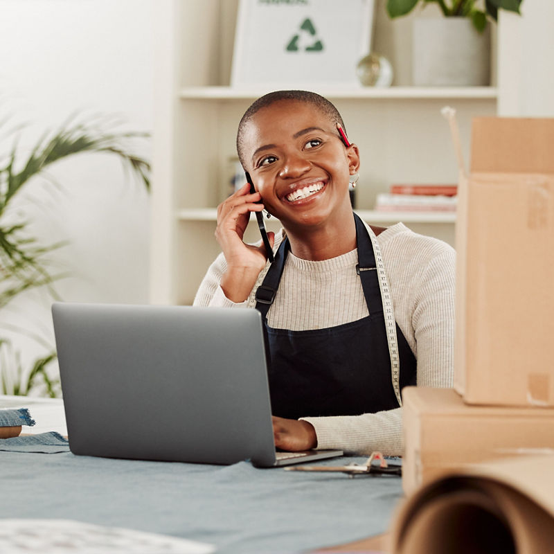 Small business owner on phone inside of boutique