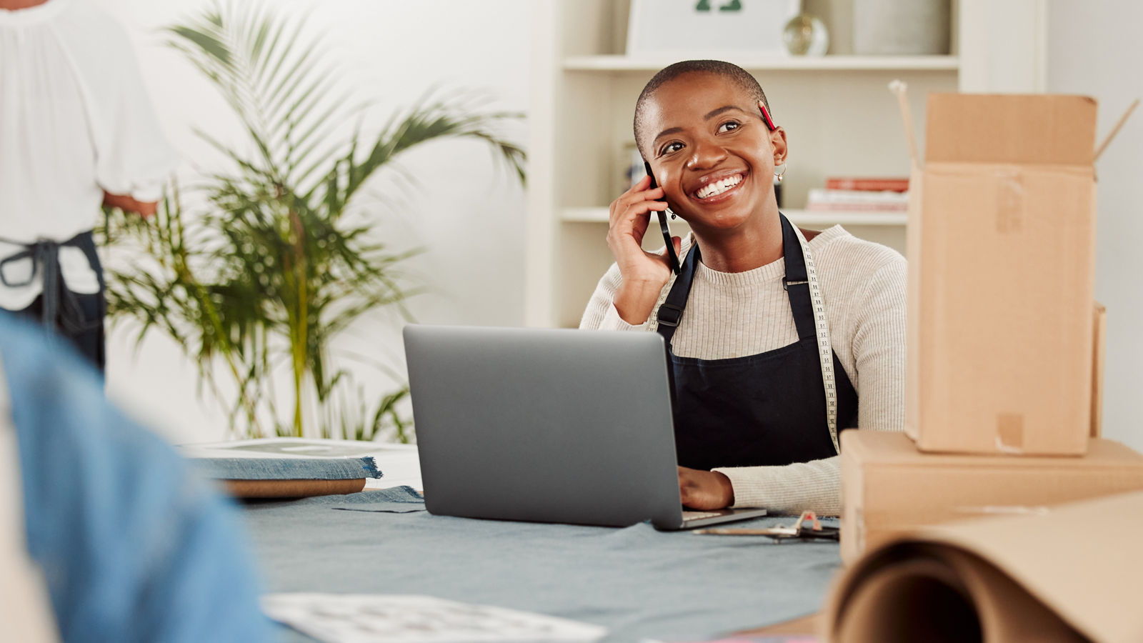 Small business owner on phone inside of boutique