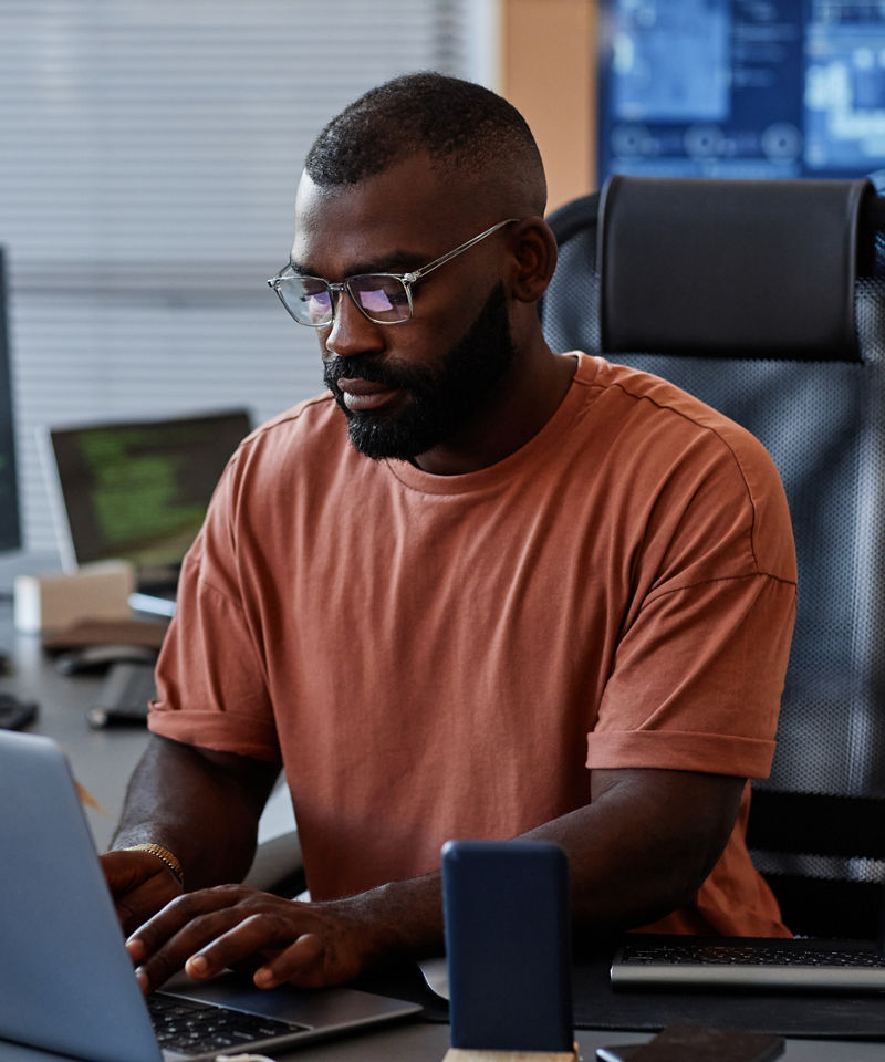 Portrait of software engineer using computer in high technology office