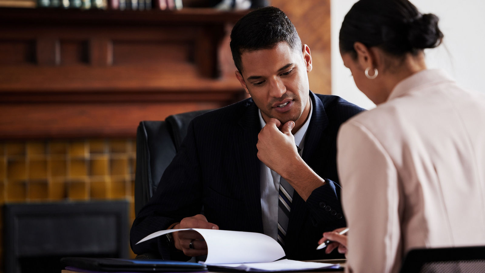 Federal worker going over paperwork with colleague
