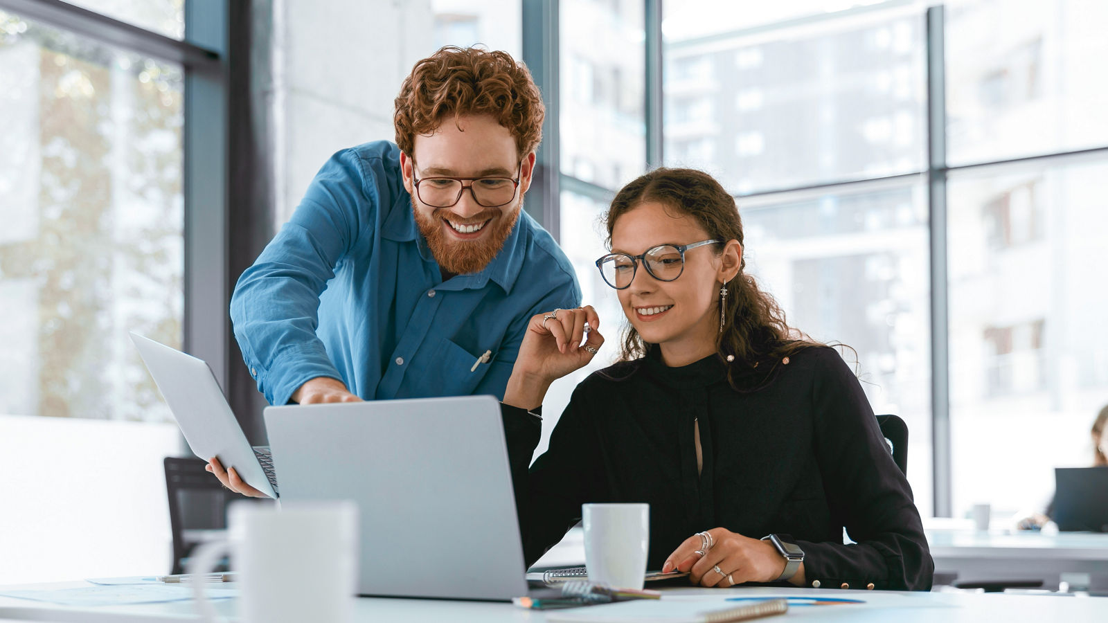 Two business colleagues using a laptop.