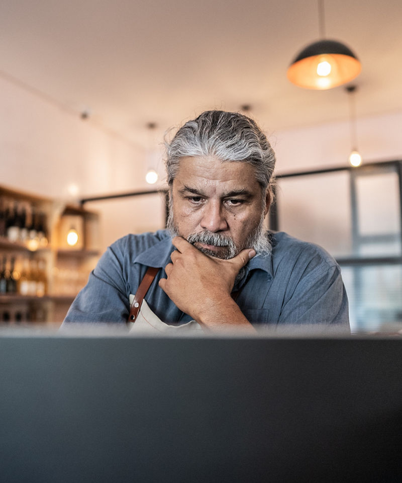 Worried business owner using laptop