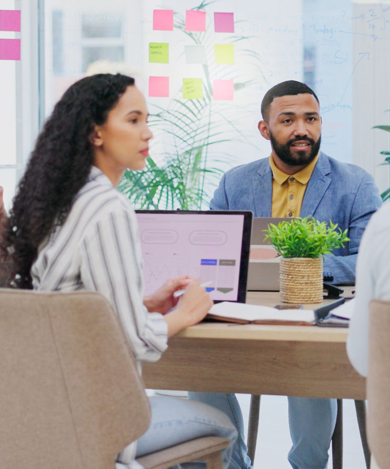 Workers in meeting room going over marketing strategy
