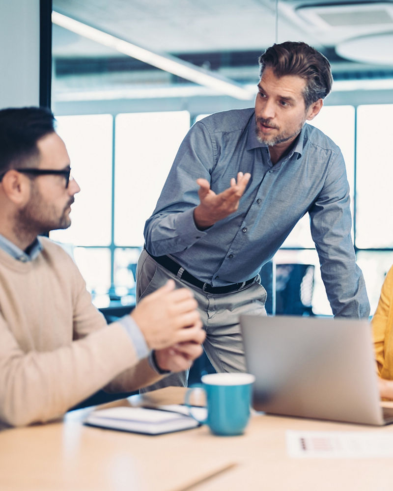 Mixed group of business people sitting around a table 