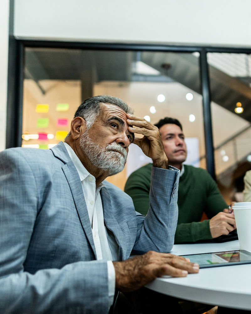 Concerned businesspeople listening in a meeting