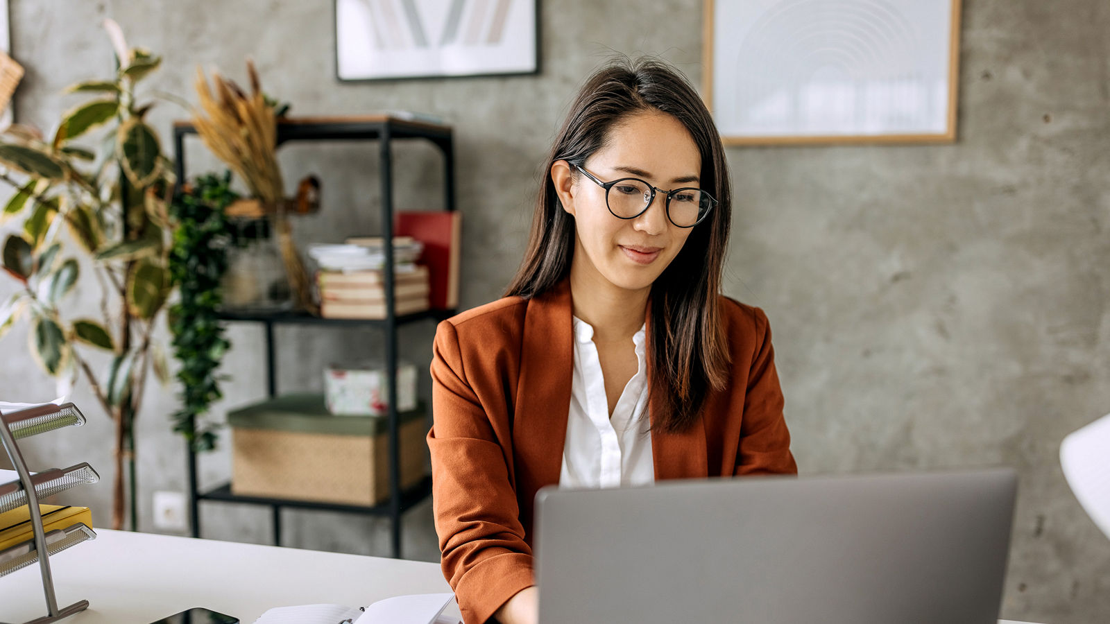 Woman sitting at a desk working on a laptop
