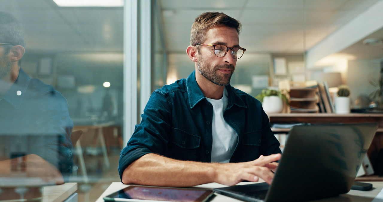 Businessman, typing and laptop in office with night, overtime and writer at publishing agency. Proposal, journalist professional and deadline for news article, reporter and employee in workplace.