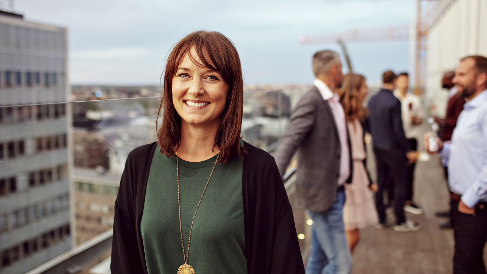 PORTRAIT OF SMILING YOUNG WOMAN IN CITY