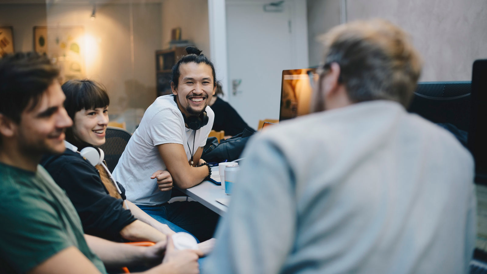 GROUP OF PEOPLE SITTING IN THE ROOM