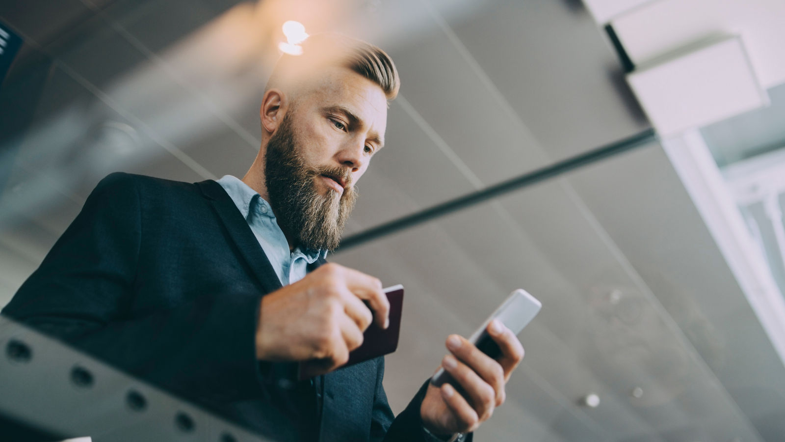MAN USING SMART PHONE