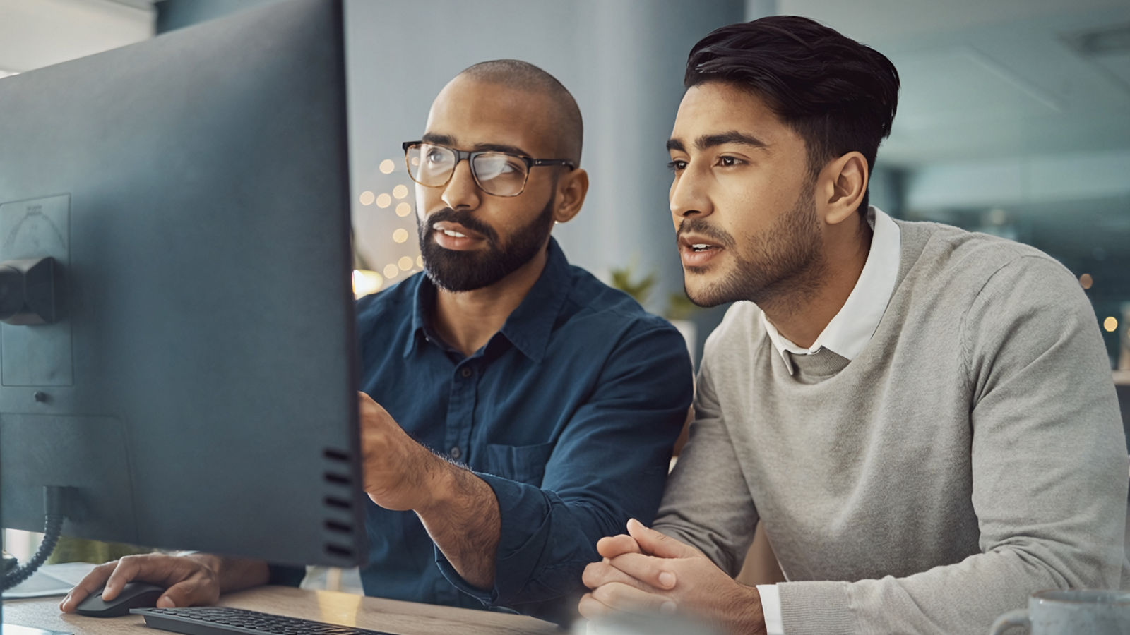 Two data scientists discussing AI progress