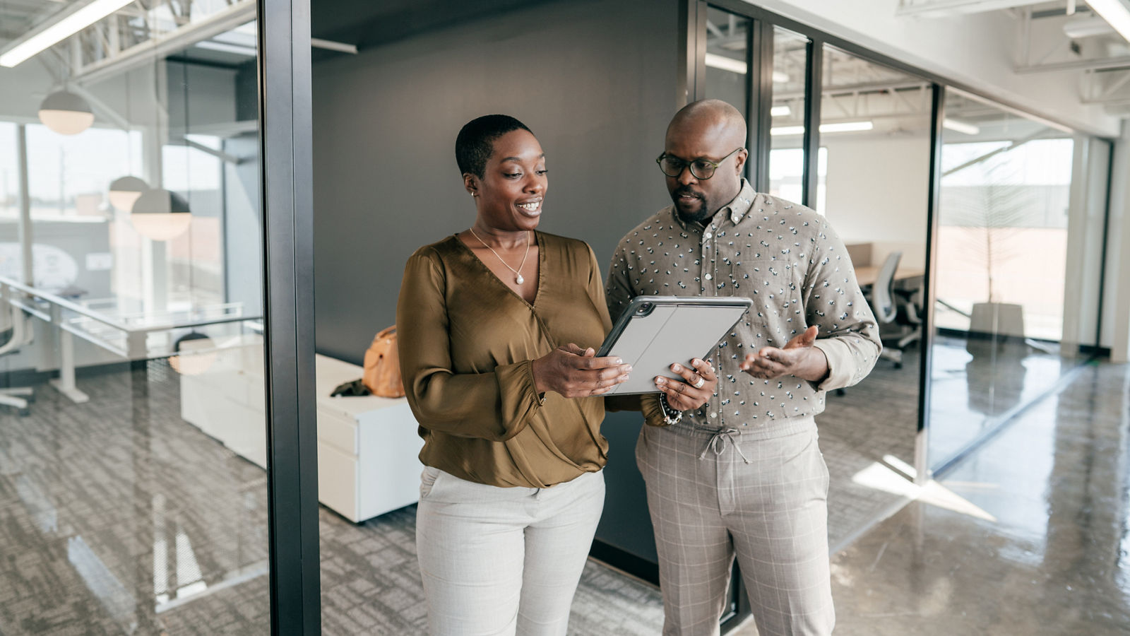 Two people having a conversation in modern office