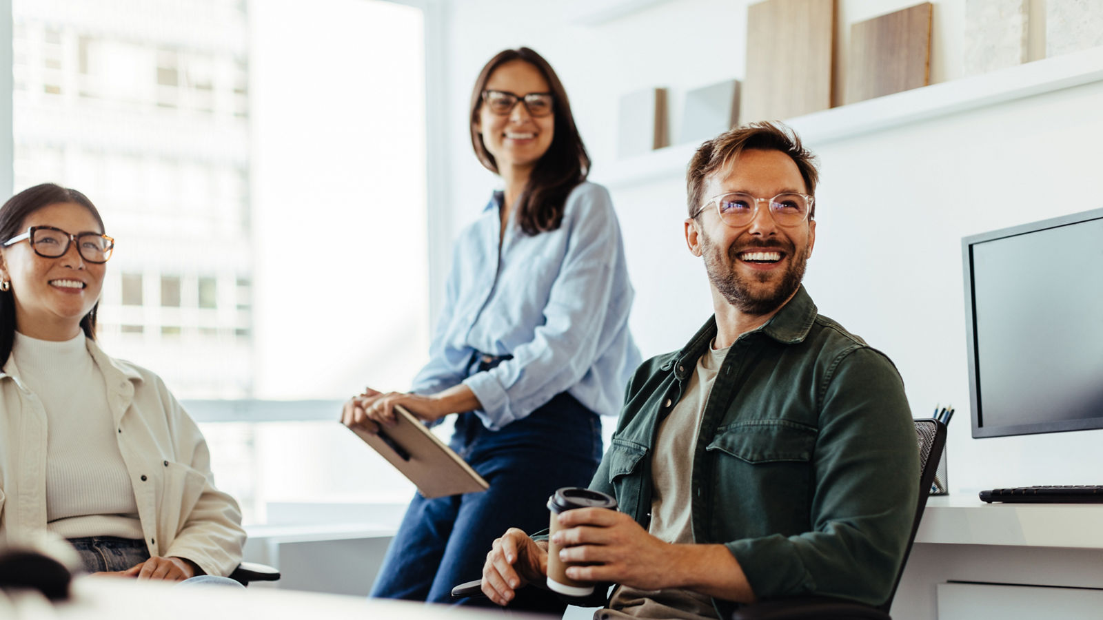 Professionals listening to a discussion in an office.