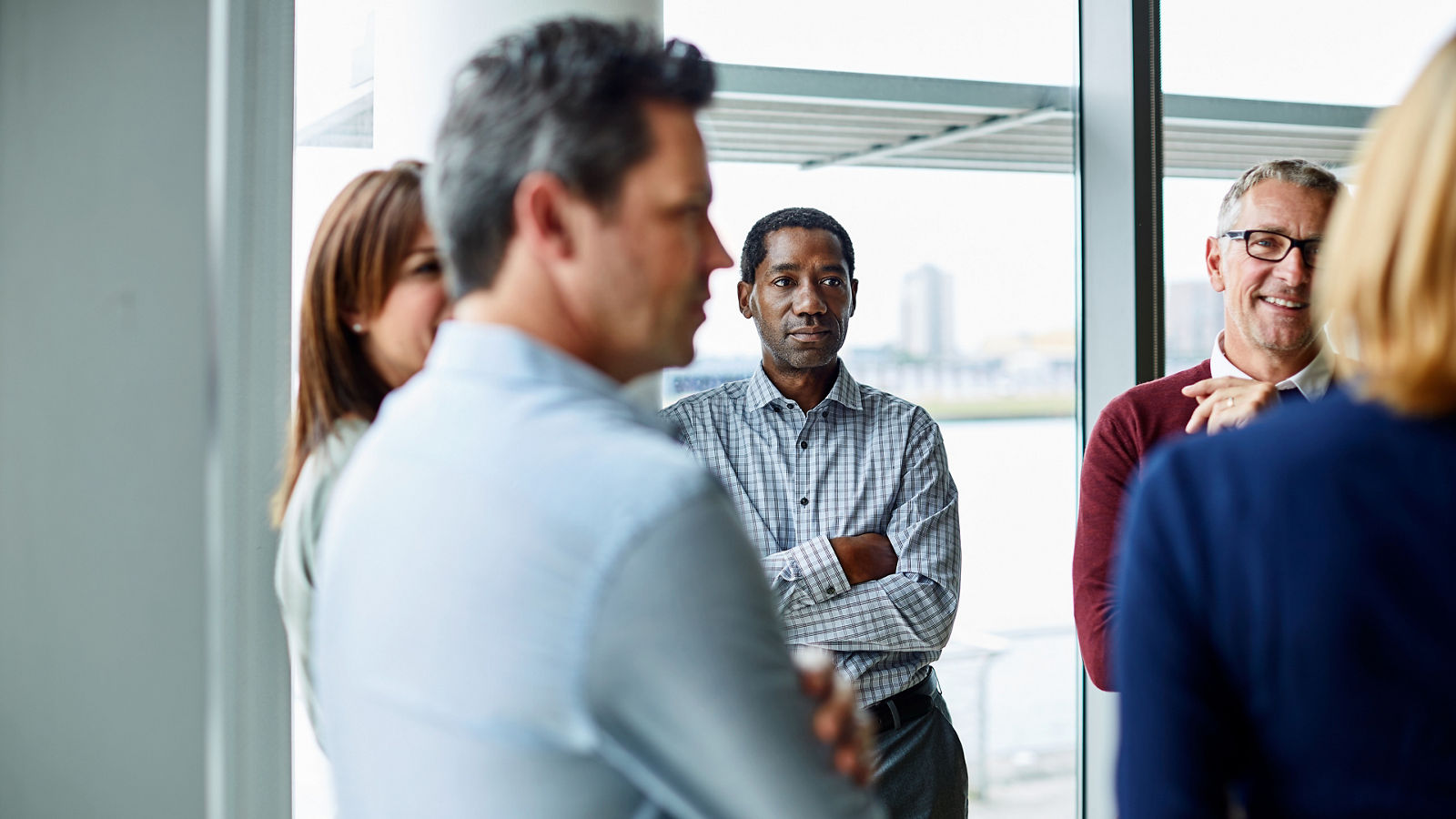 Shot of a group of colleagues talking together in a modern office