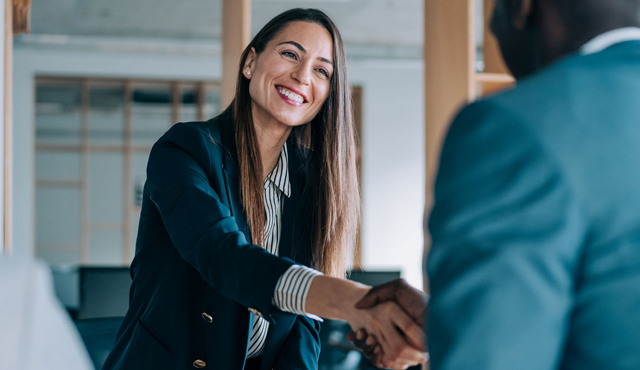 Image of woman shaking clients hand