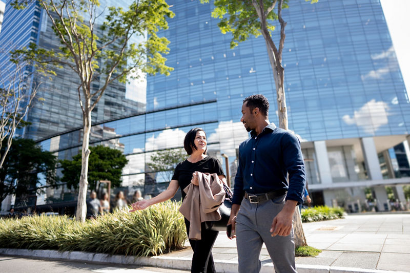 Coworkers talking while walking outside