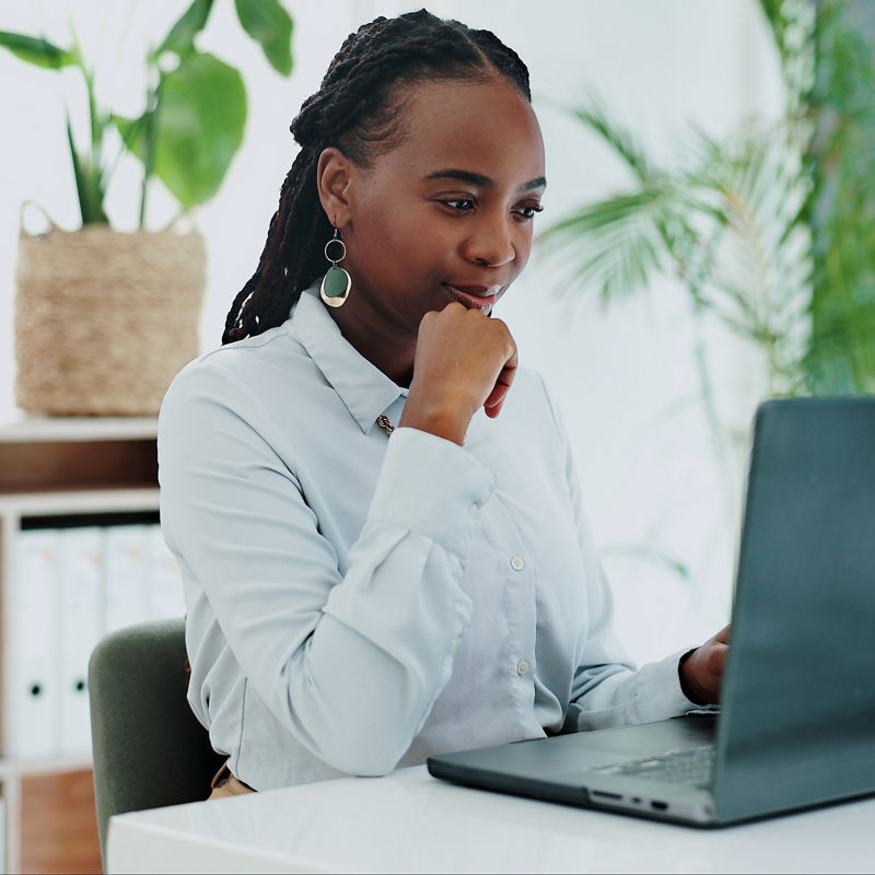 Business woman, thinking and laptop for online research in office and information on digital tech at desk. Black person, editor and inspiration on internet and creative writing on computer on blog