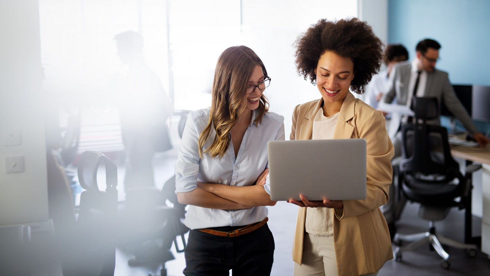 Happy multiethnic smiling business women working together in office