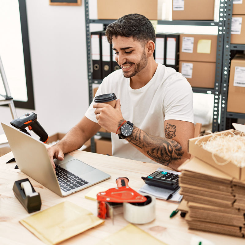 Young hispanic man working at small business ecommerce with laptop smiling with a happy and cool smile on face. showing teeth. 
