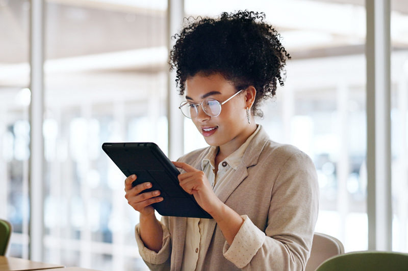 Woman in business clothing looking at tablet