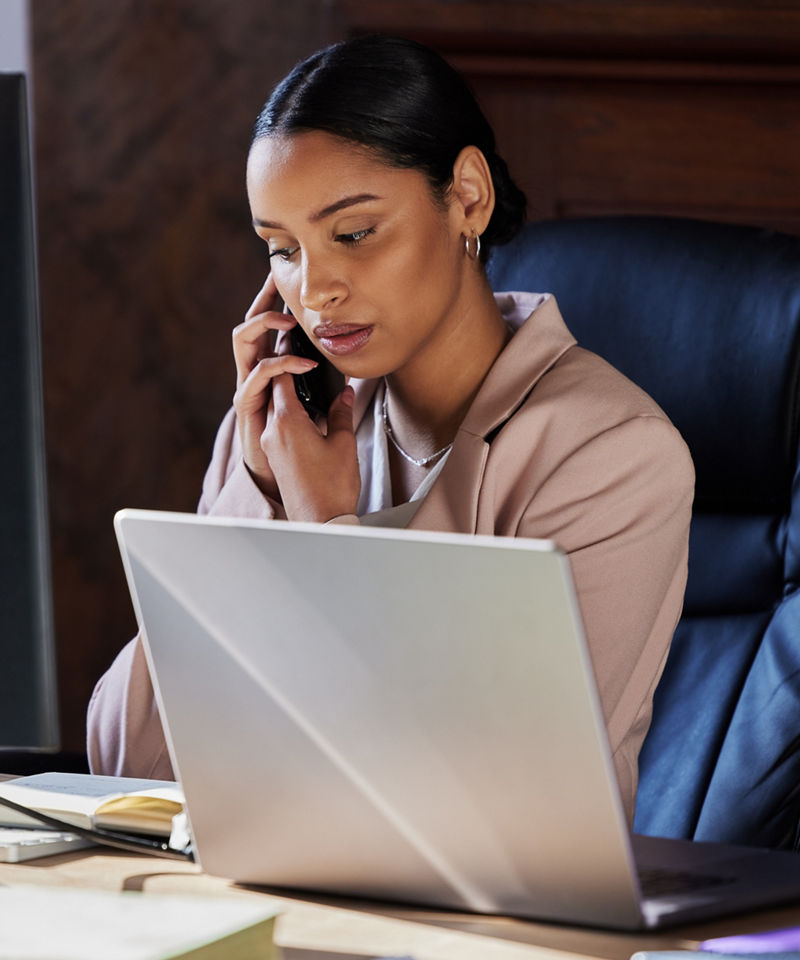 Business woman on phone and computer working in office